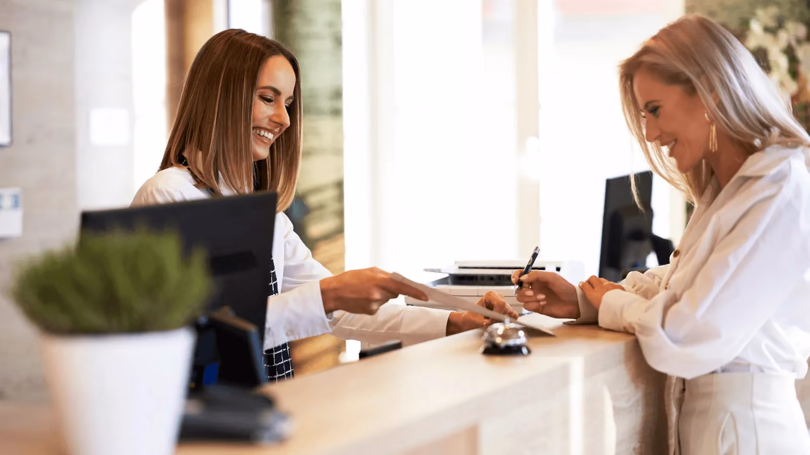 Woman smiling at person in line at an event table