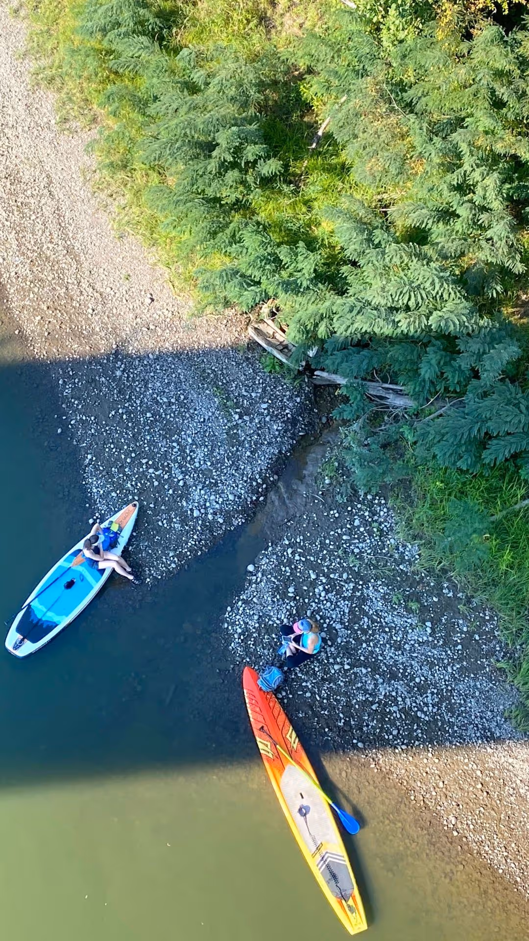 Two colorful kayaks on the riverbank of the columbia river