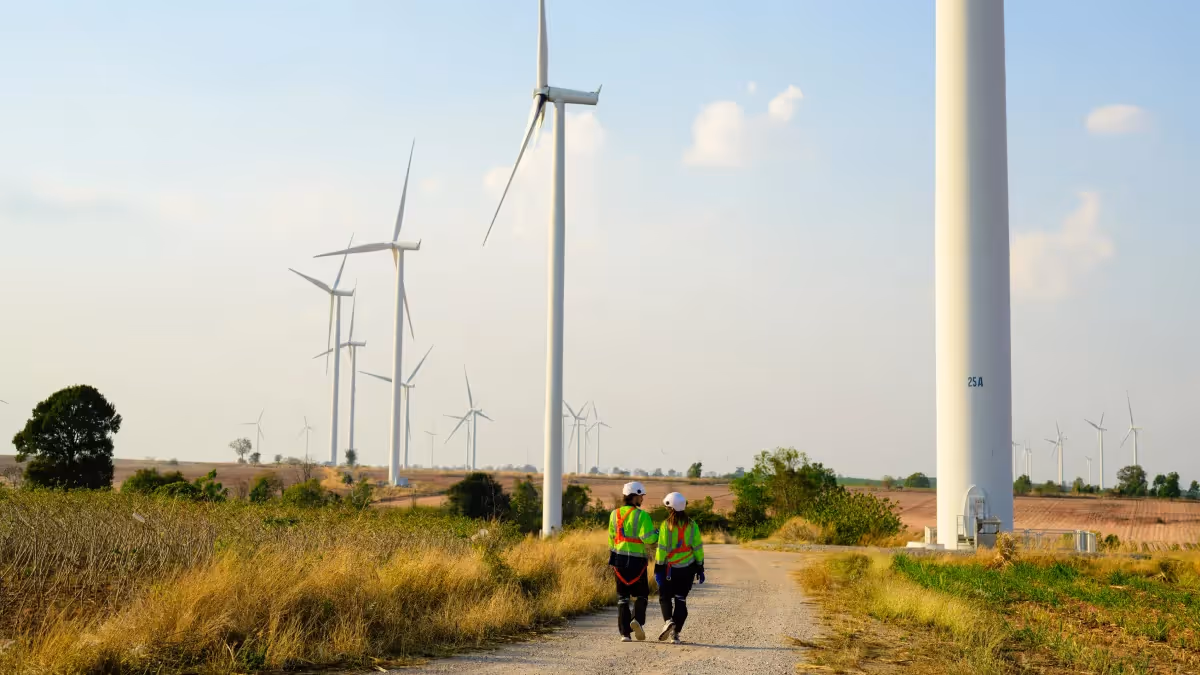 Technicians walking near wind turbines