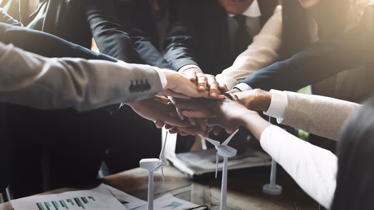 Business people with all hands on top of one another