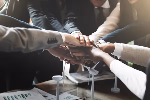 Business people with all hands on top of one another