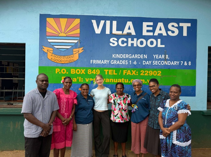 Vanuatu WLI alumni and others standing outside at Vila East School