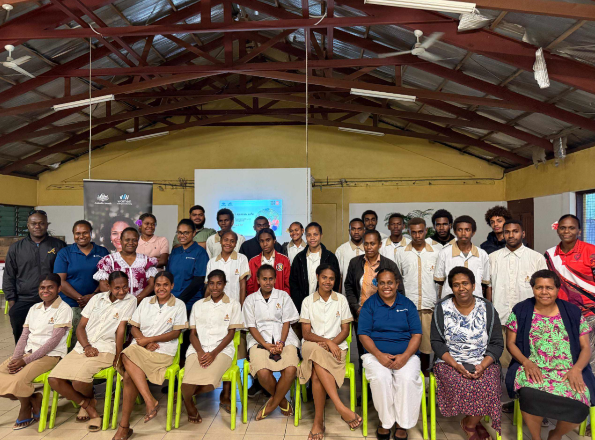 workshop facilitators sitting and standing, smiling for photo