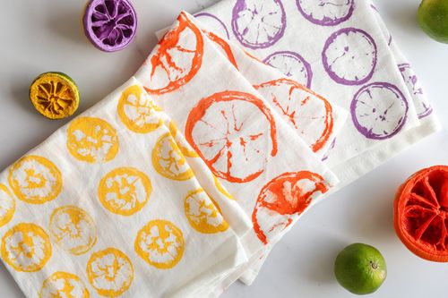 Tea towels printed with citrus leftovers and paint