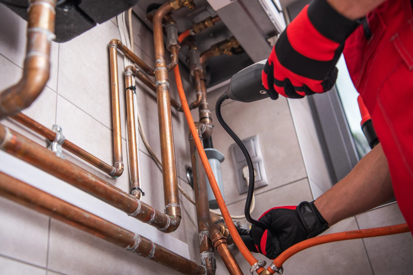 Plumber inspecting pipes during rooter service