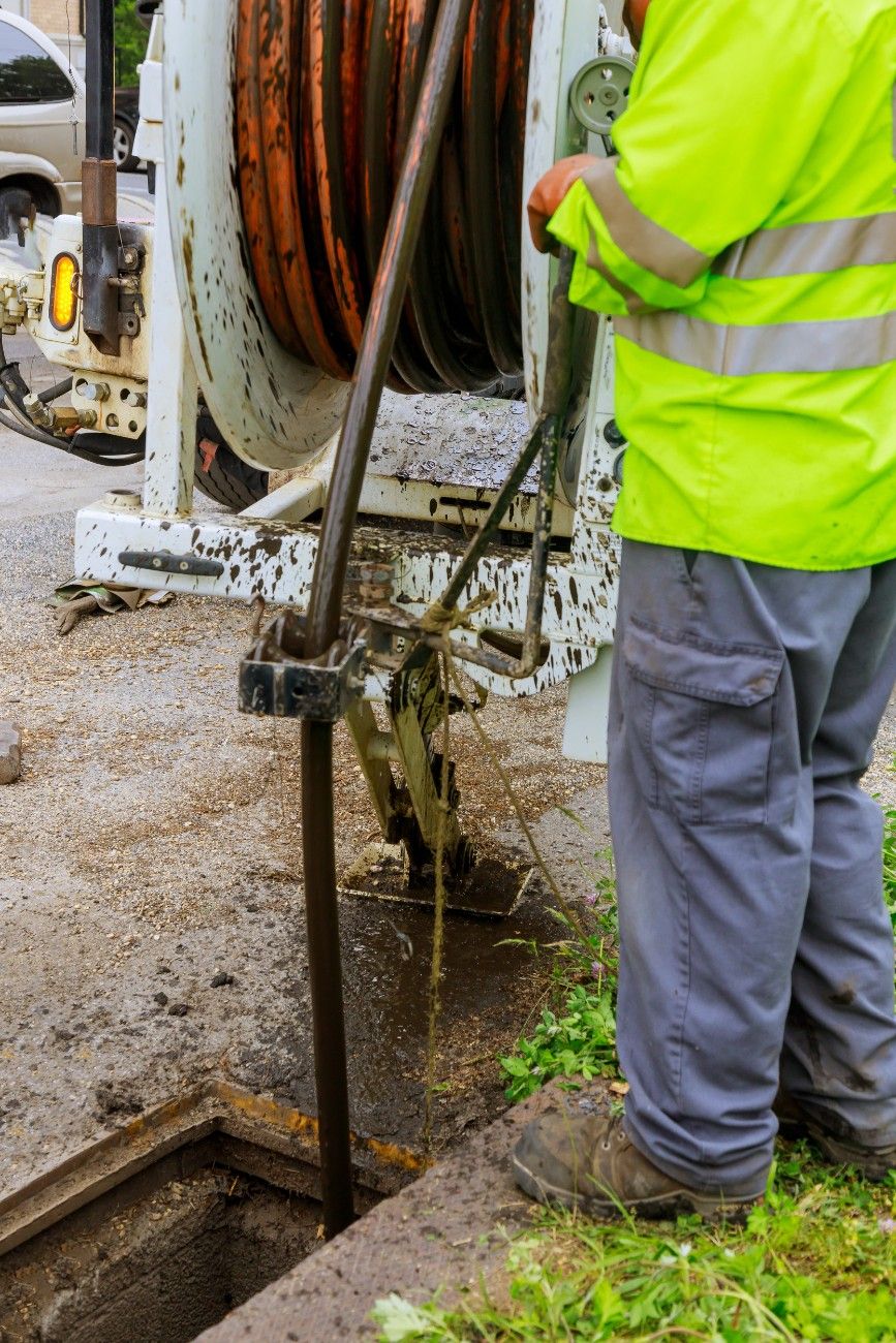 Contractor rolling out a hydro-jetting hose to clear a sewer line in Seattle