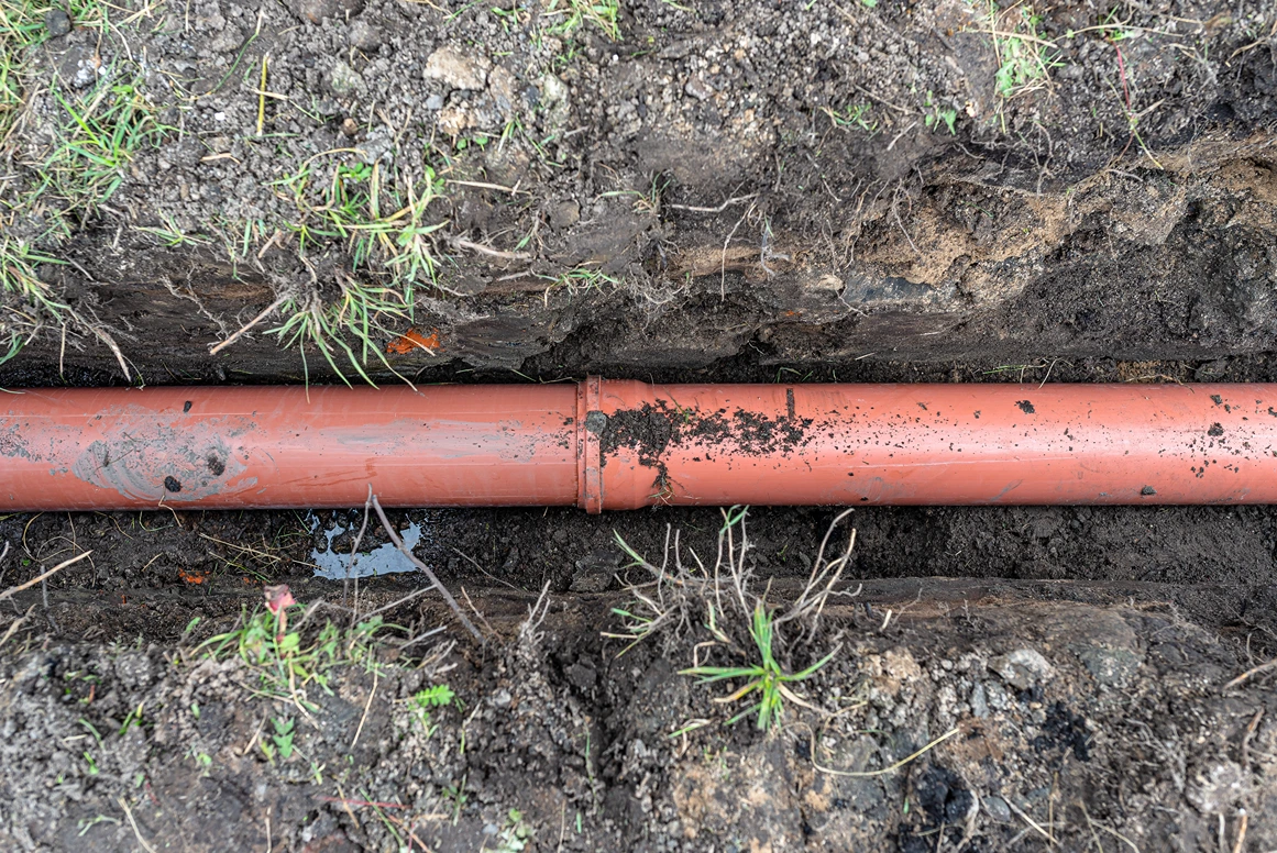 A newly installed sewer pipe in an open trench of a Seattle property
