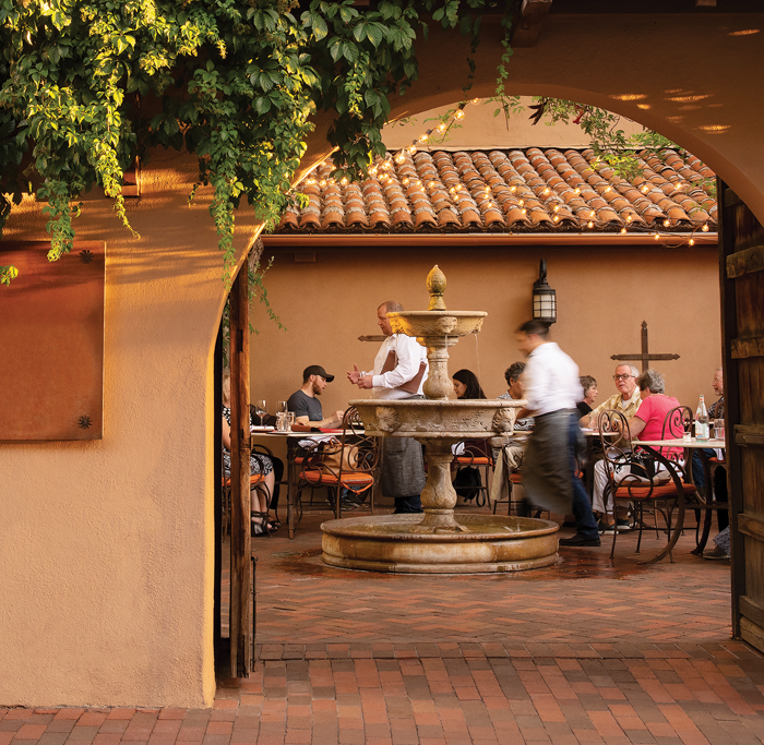 Wolf and Roadrunner patio with fountain and people dining
