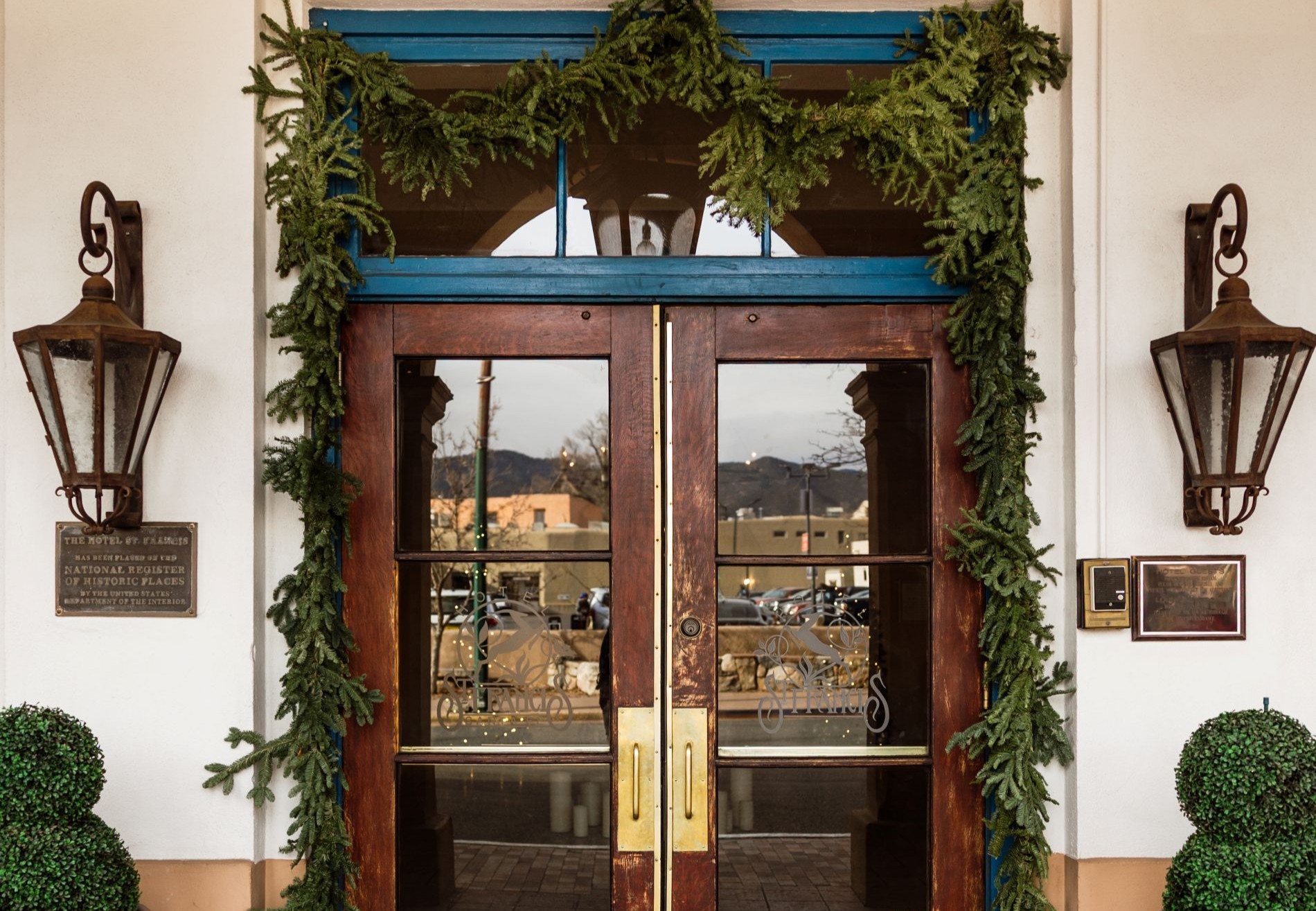 Doors to Hotel St. Francis with green garland hunt over entrance