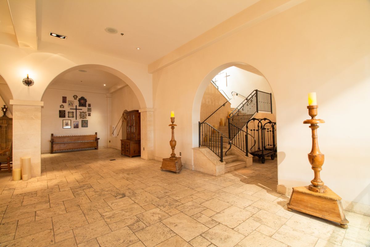 Serene entryway to wrought iron staircase