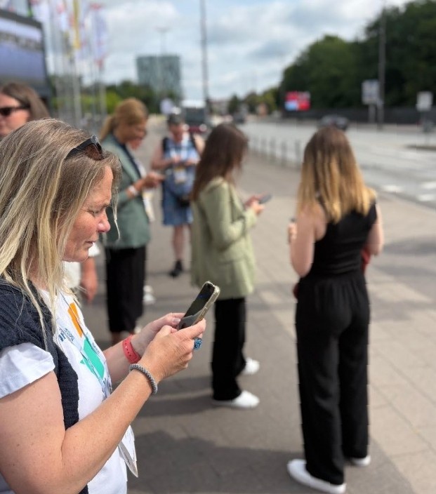 Photo of walkshop participants answering survey questions on their phones.