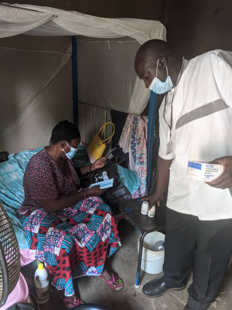 A health care professional prescribing medication for a patient sitting down