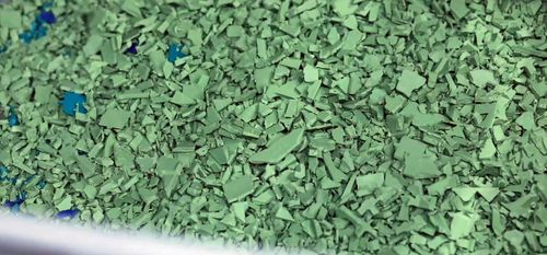 An image of designer Ineke Hans holding the chair as if it where to be recycled.