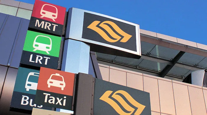 A road sign showing directions to the nearest MRT, LRT, Taxi and Bus stations.