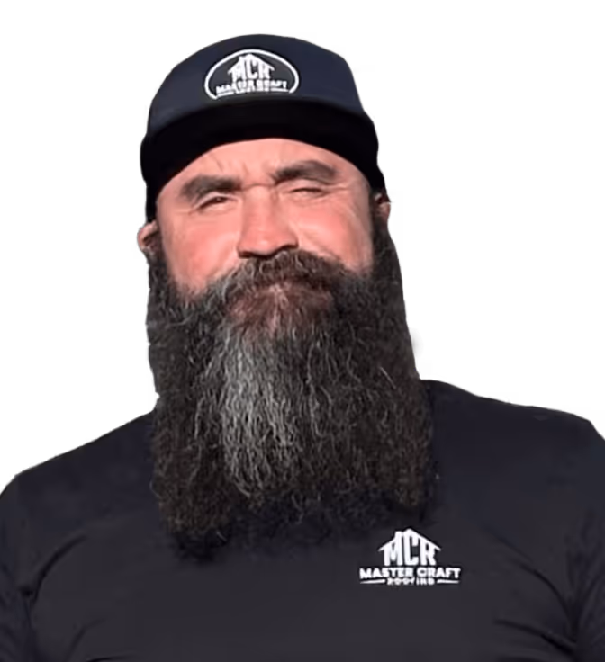 Man with a long gray and black beard wearing a black Master Craft hat and shirt.