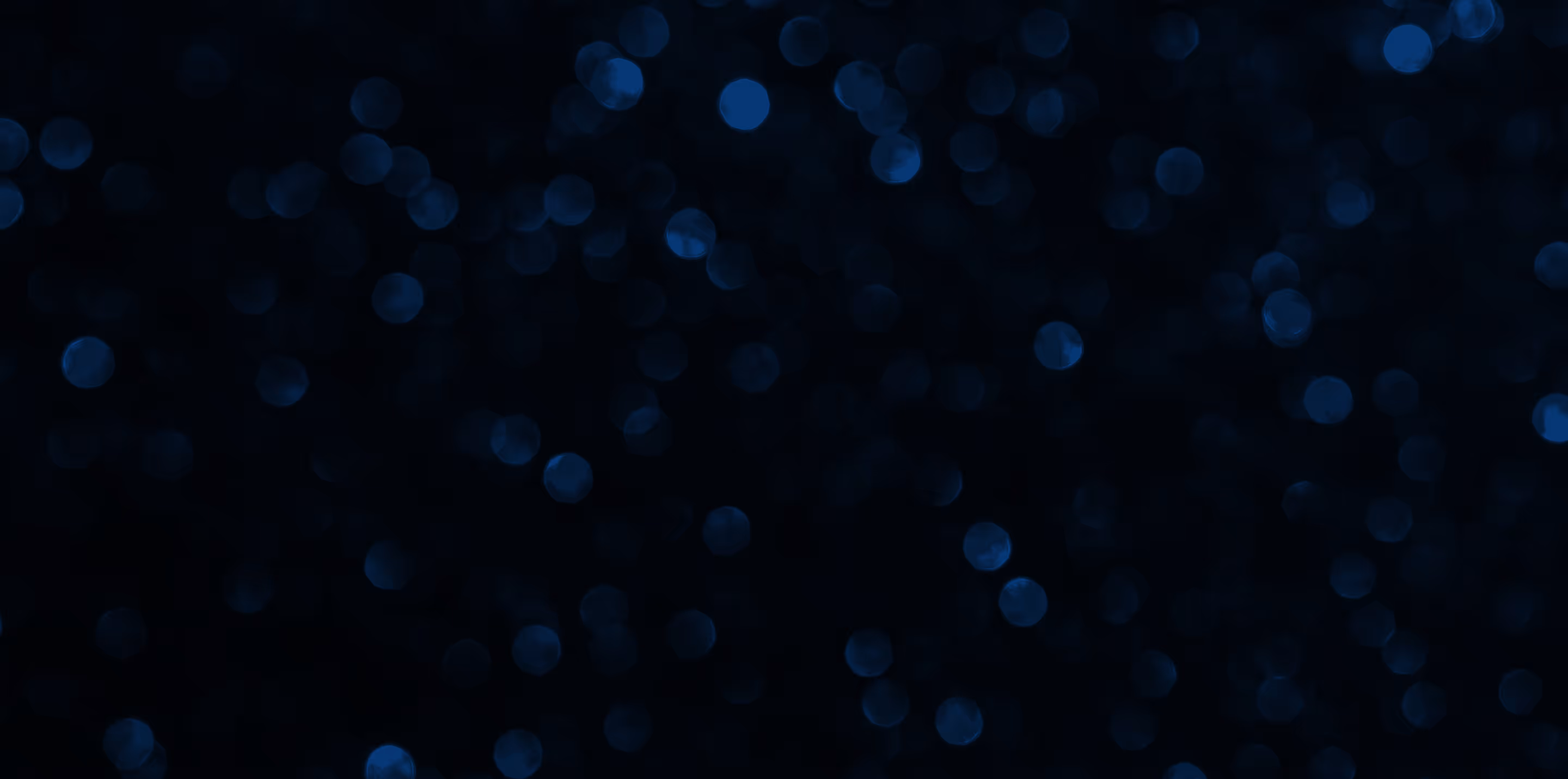 Dark background with scattered soft-focus blue light bokeh dots.