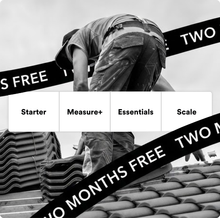 Black and white photo of a roofer wearing work clothes and a hat, installing roof tiles on a rooftop.
