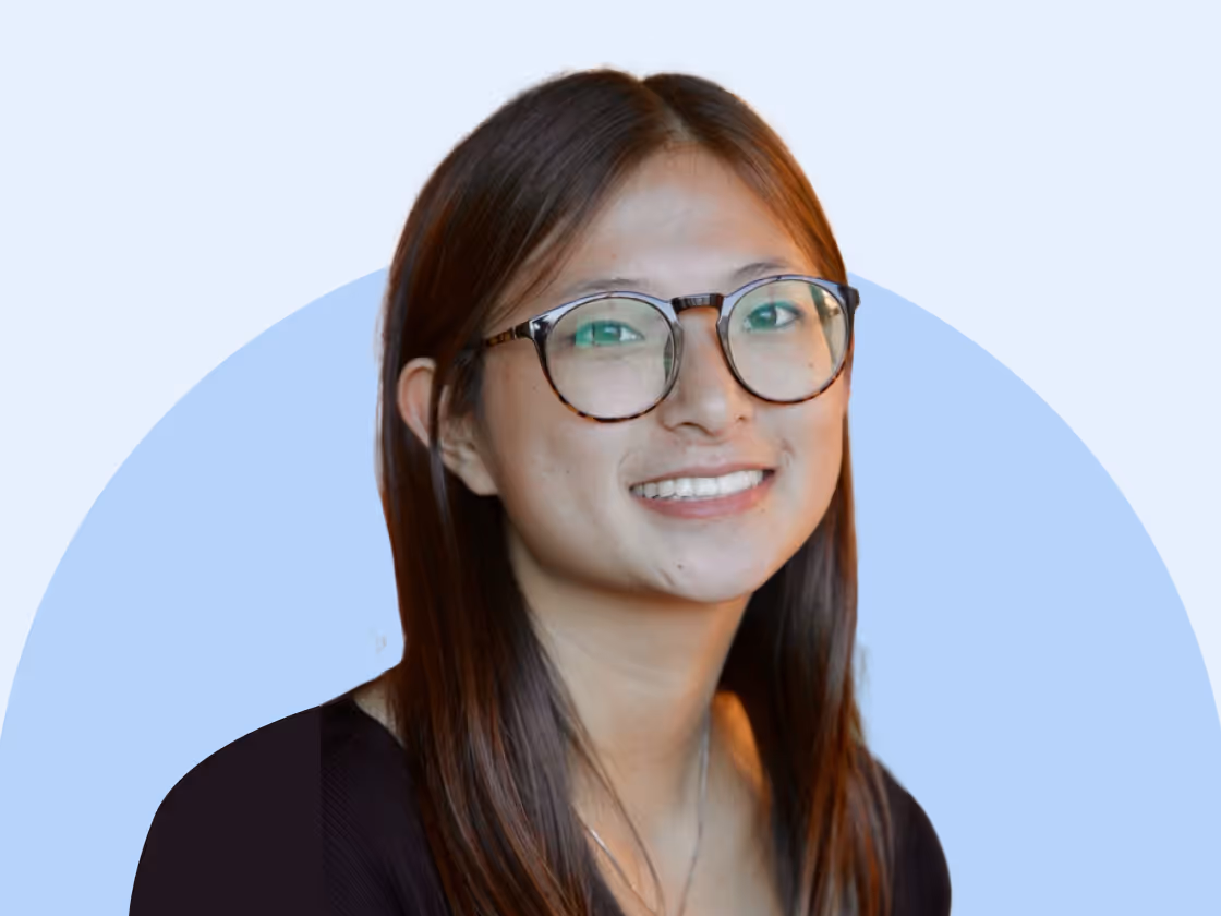 Roofr team member with glasses in a friendly, professional portrait.