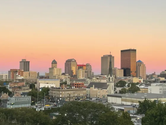 Sunset over the skyline of downtown Dayton, Ohio, one of the top U.S. markets for roofers in 2026.