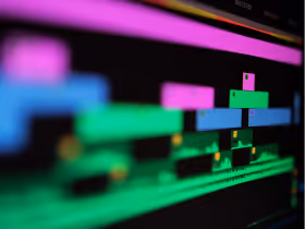 Colorful bars stretching across a computer screen, representing AI-assisted multi-track video editing or clipping.