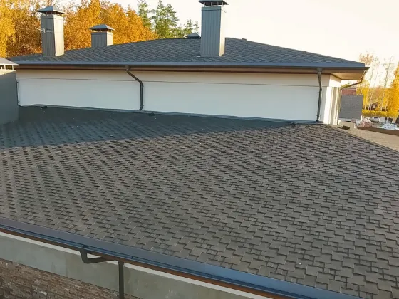 A photo of a large residential upcycled roof made of recycled rubber shingles.
