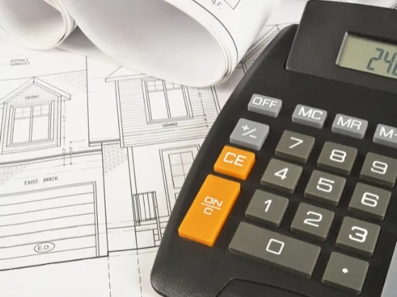 Calculator on top of paperwork used to calculate roof estimate