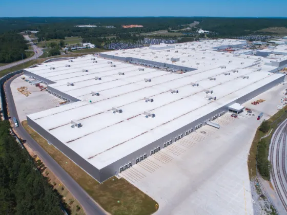 An aerial shot of a large commercial building complex, showing an example of TPO roofing from above.
