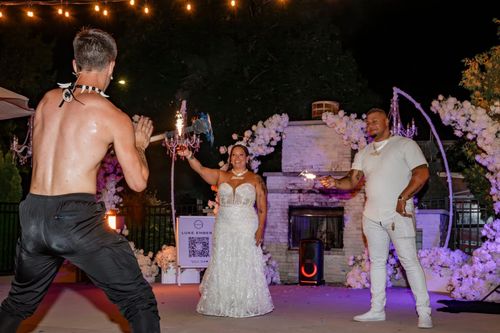 Luke Embers fire dancing with wedding couple.