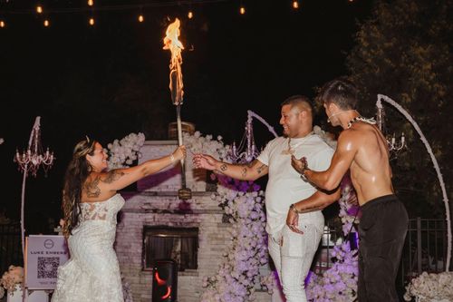Luke Embers fire dancing with wedding couple.