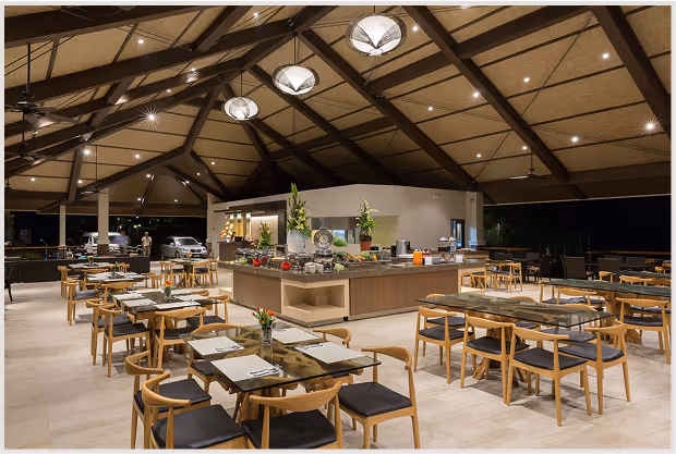 Upscale resort dining area with modern tables, open layout, and buffet station.