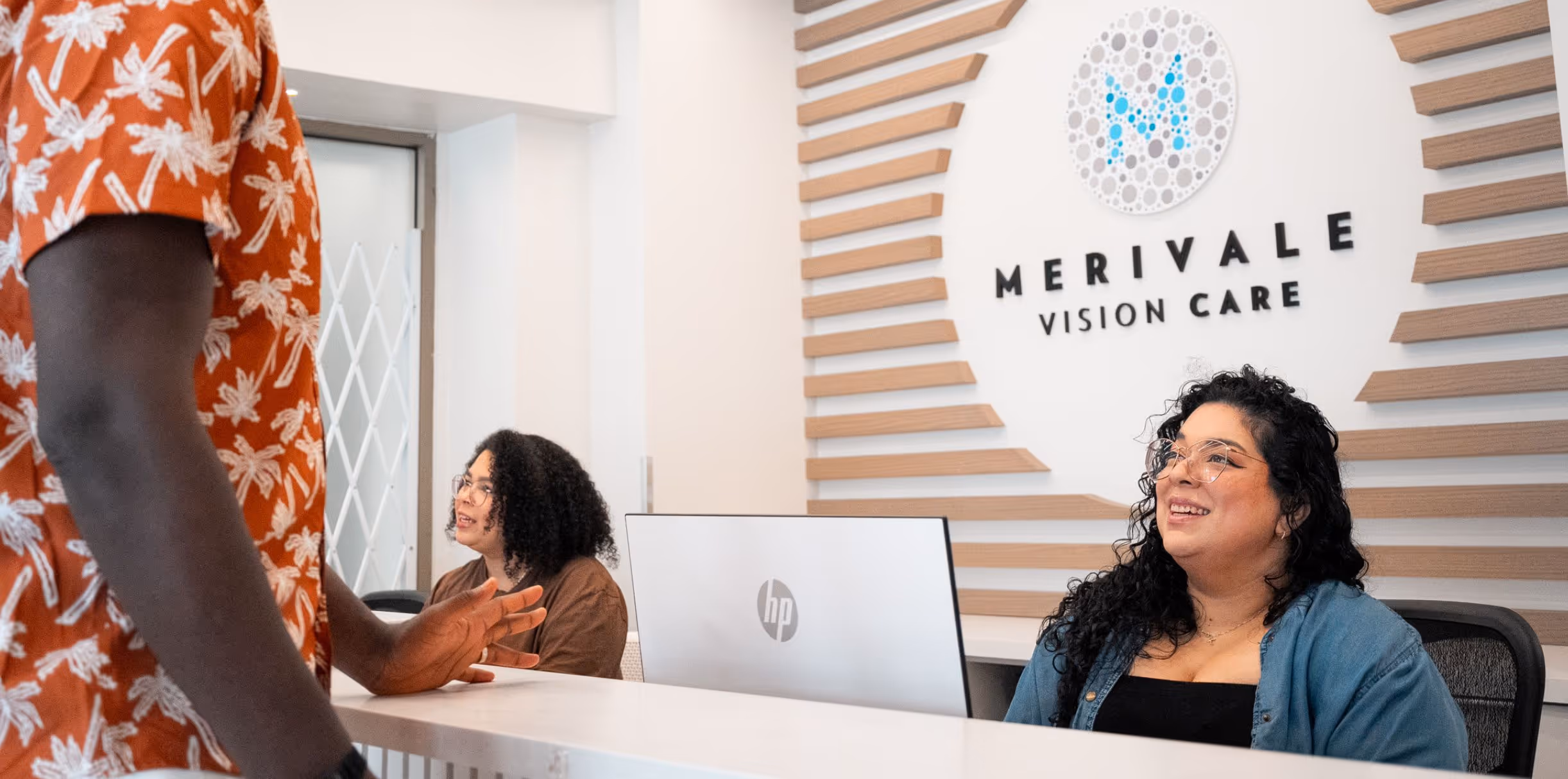 Team member welcomes a patient into Merivale Vision Care.