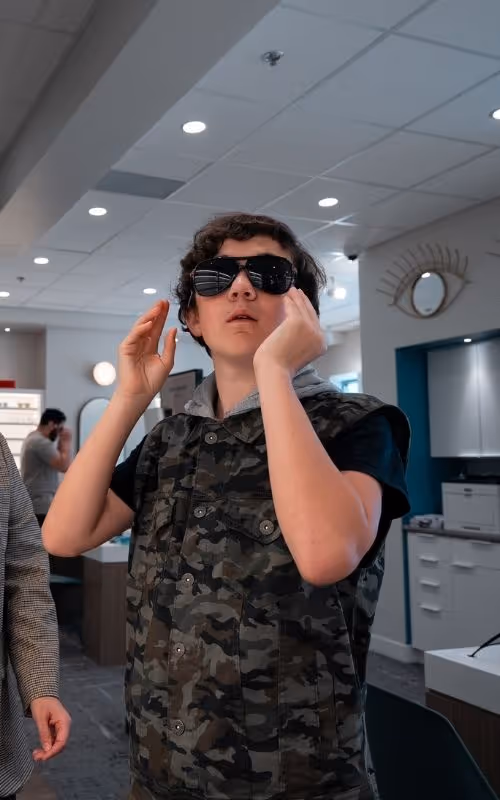 Client at Merivale Vision Care trying on a pair of prescription sunglasses.