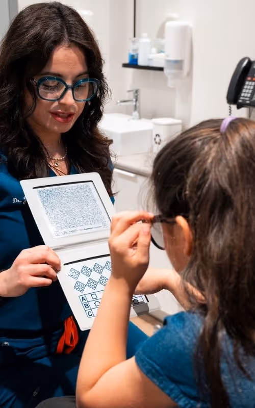 Optometrist at Merivale Vision Care performing a children's vision exam.