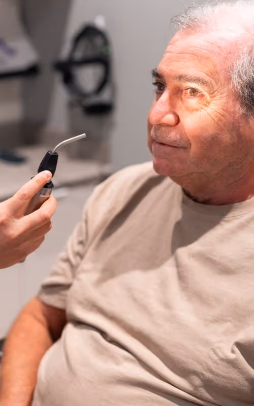 Merivale Vision Care Optometrist performing an eye exam with a patient.