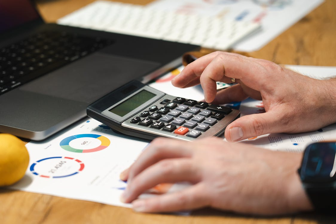 man hands over calculator