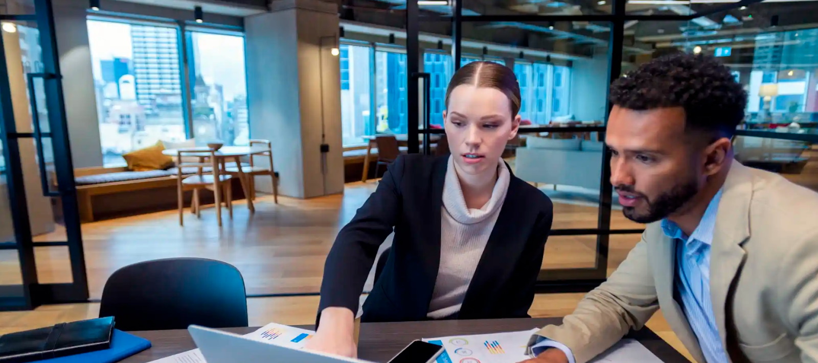 2 staff working infront of a laptop