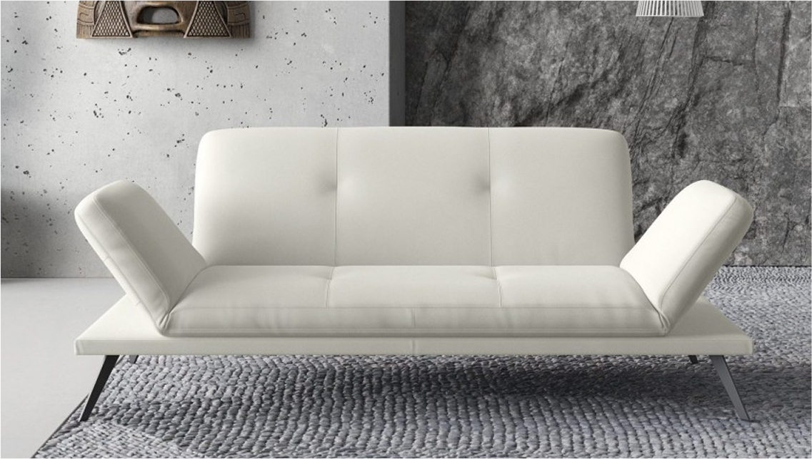 A modern white armless sofa with adjustable sides on a textured gray rug.