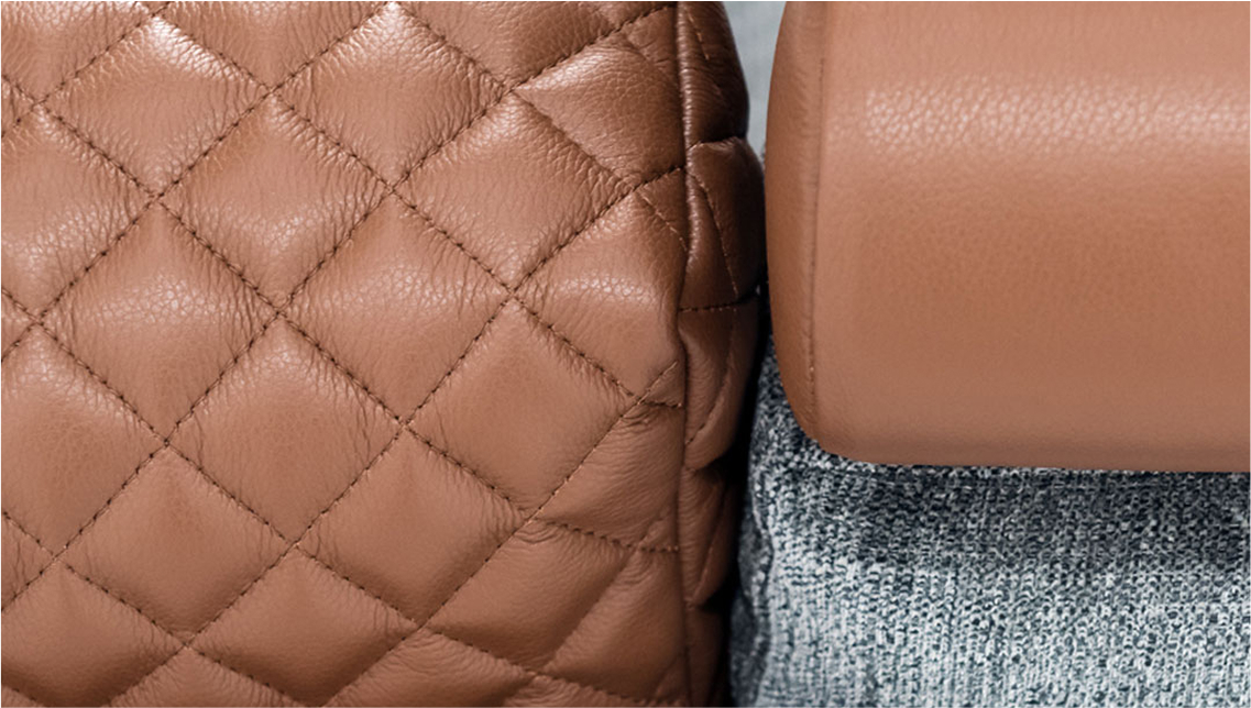 Close up of leather sofas in dark tan with light stitching