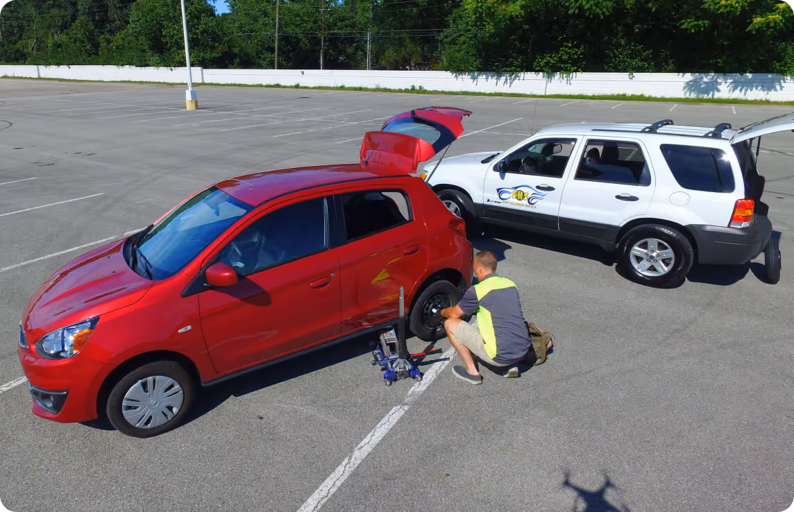 Image of Sam changing a tire for a customer
