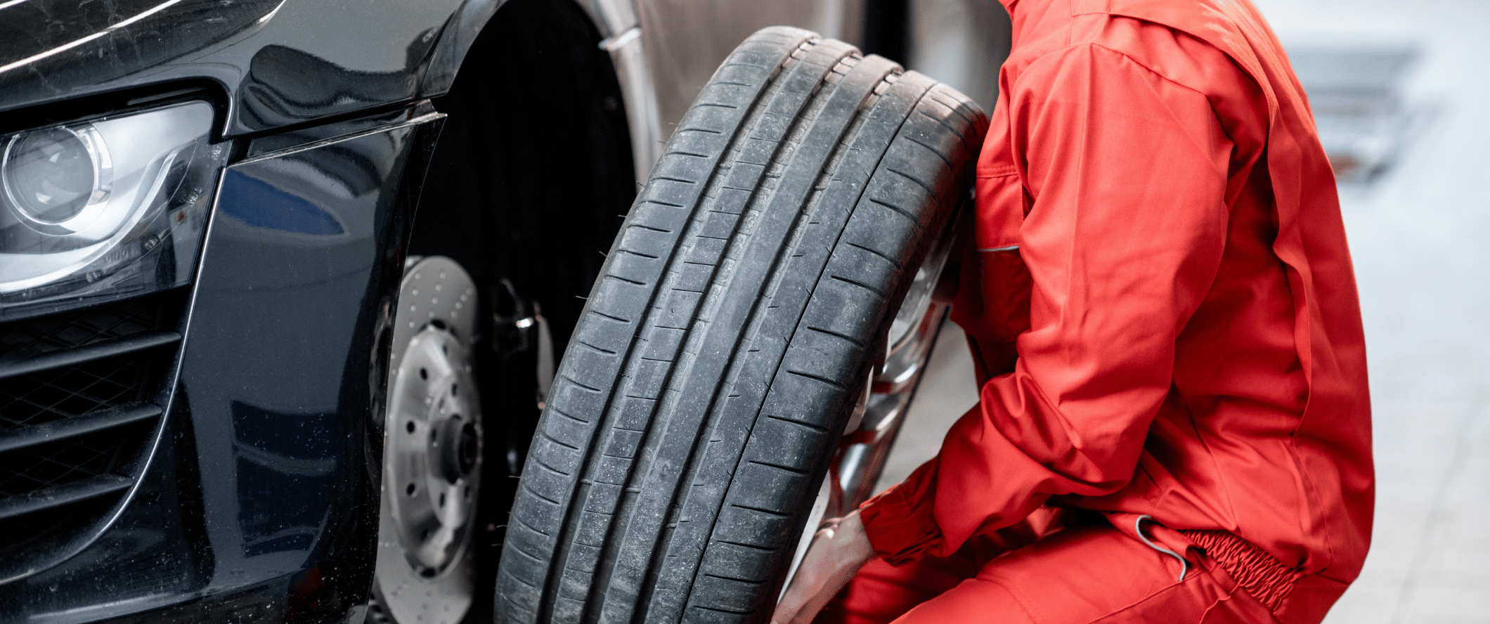 Image of a Sam's Roadside Service technician mounting a tire on a car