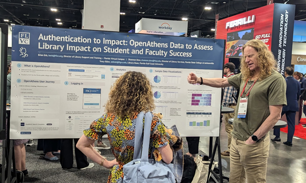 Brian Erb presenting poster to conference attendees