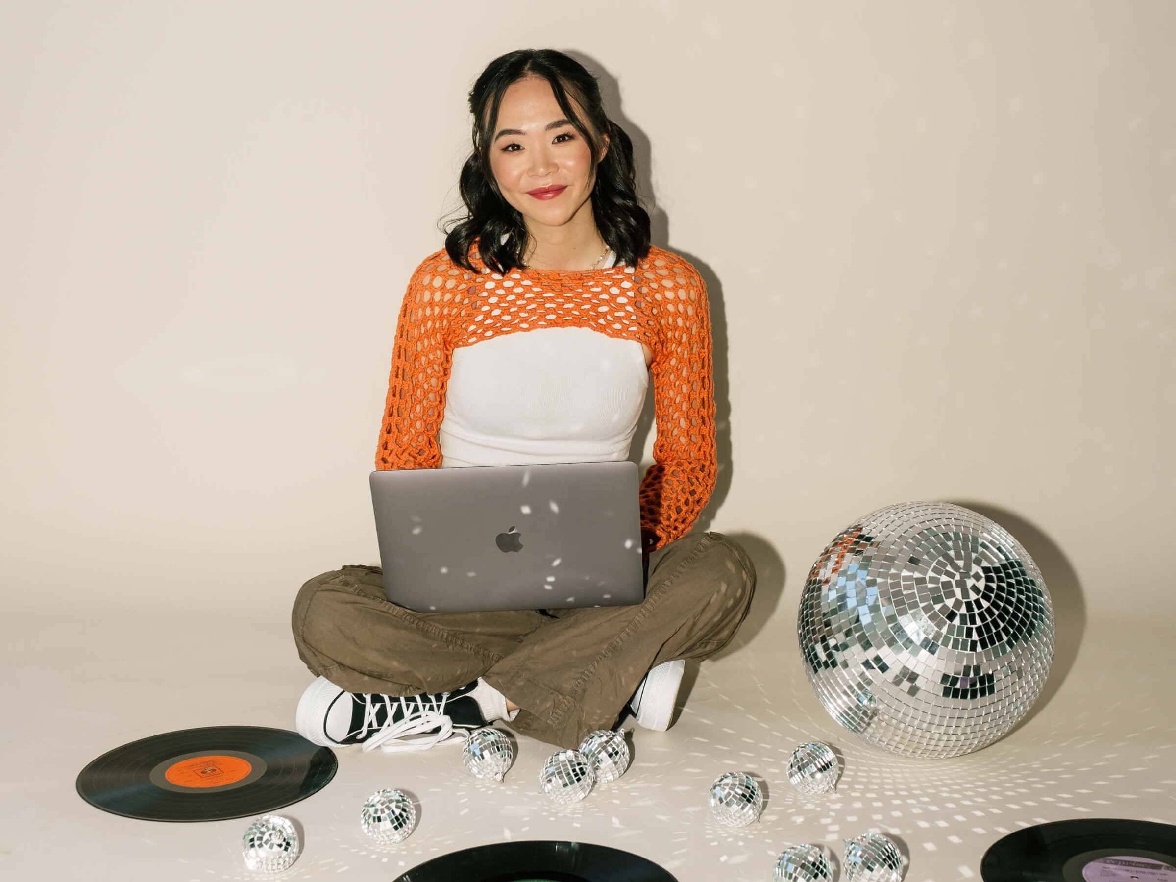 Olivia Su, website designer, smiling at camera with laptop in lap