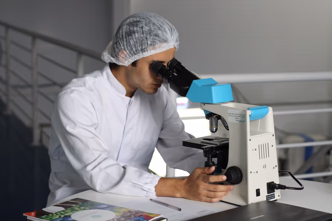 image of scientist looking into microscope
