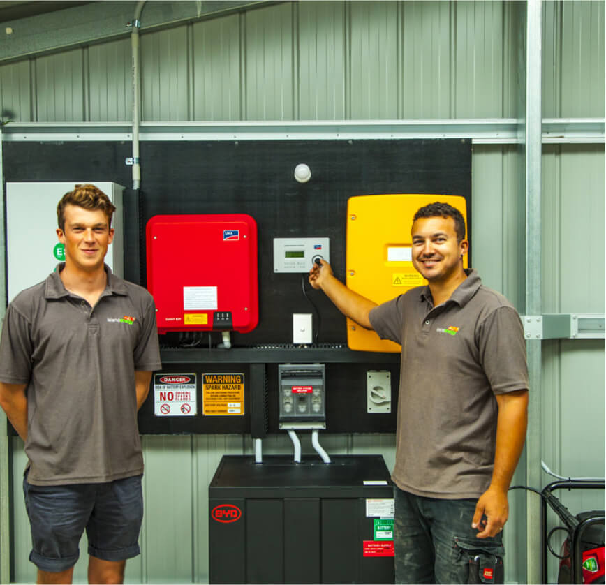 Island Energy Team members in front of a new off grid system installation.