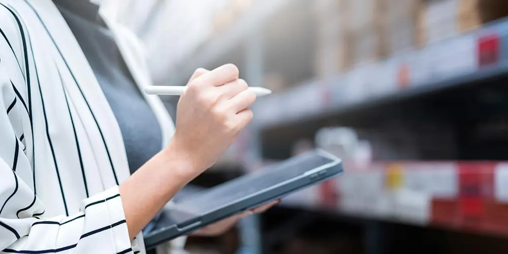 close up female business owner hand hold tablet device checking inventory stock shop warehouse distributor factory business ideas concept