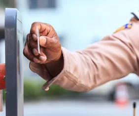 A security guard is scanning an event ticket QR Code to protect it from trespassers. 