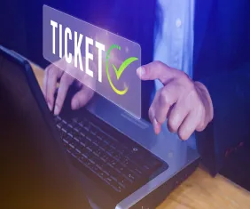 A man sits in front of a laptop, learning about Ticket Generator API integration.