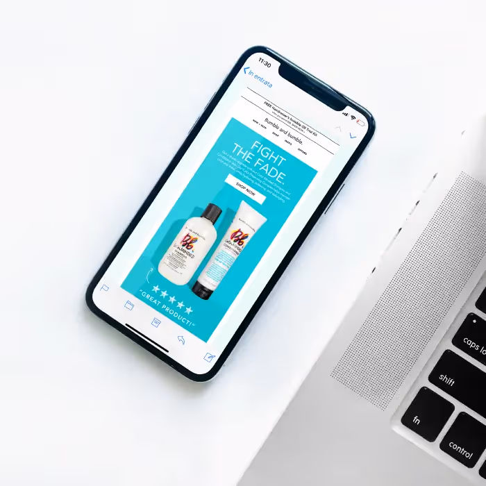 Smartphone displaying Bumble and Bumble email ad with “Fight the Fade” headline and haircare product images.
