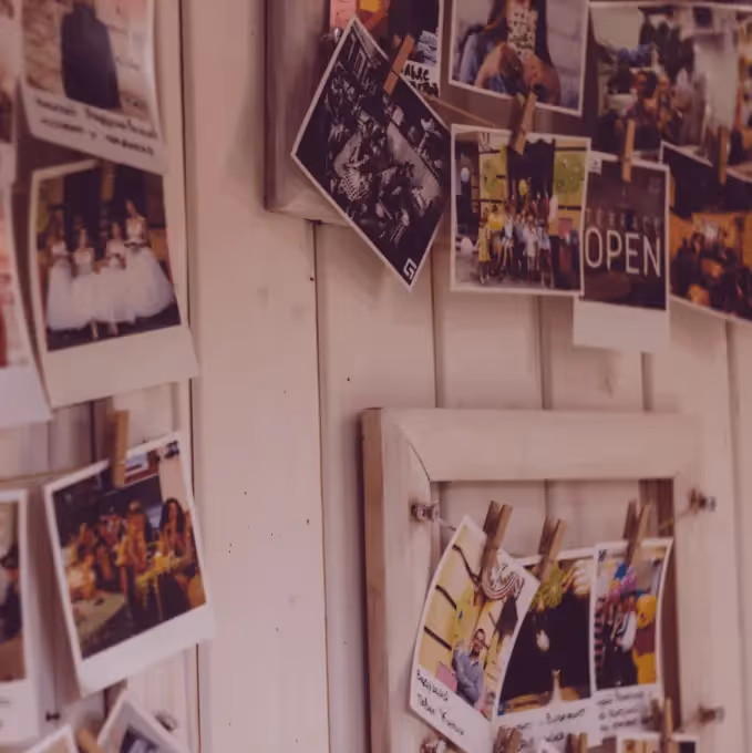 Polaroid-style photos pinned on a wall, representing the concept of showcasing user-generated content in emails.