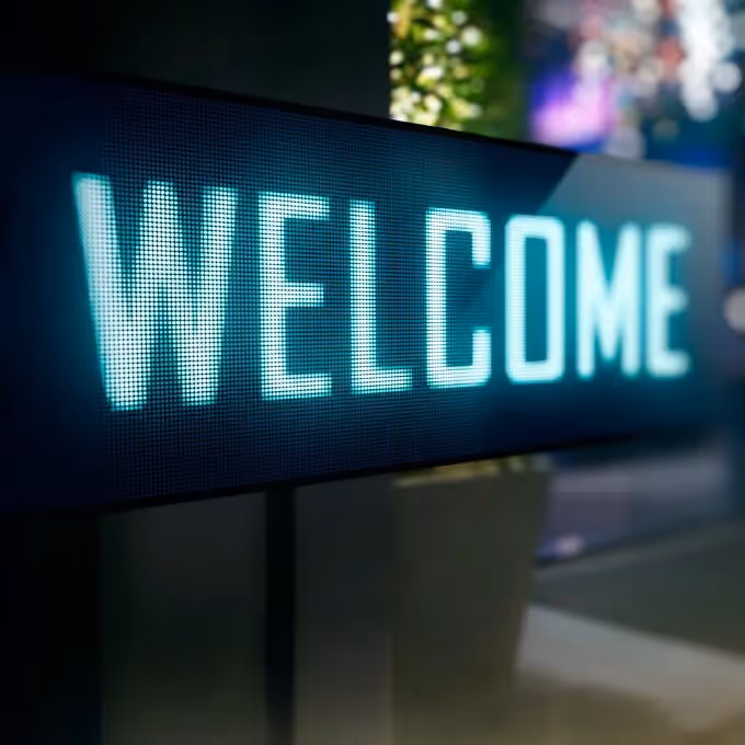 A glowing digital sign displaying “WELCOME,” symbolizing tips for creating standout and engaging welcome email designs for brands.